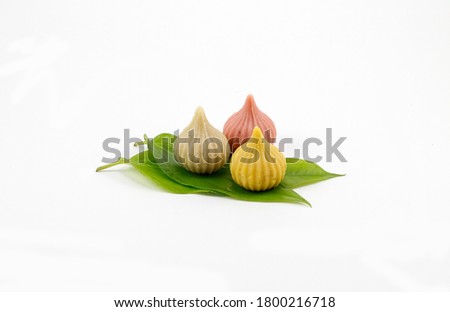 Modak made from khoa is an Indian sweet dumpling offered to Lord Ganapati on Ganesh Chaturthi Festival. variation of modak is prepared Served in a plate. Selective focus Royalty-Free Stock Photo #1800216718
