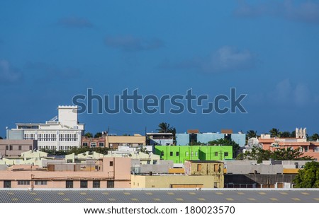A bright green building in midst of colorful skyline in San Juan under Blue Dusk
