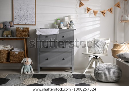 Chest of drawers with changing place in baby room. Interior design