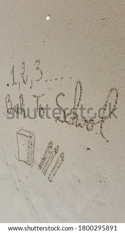 Back To School message written on a beach , end of summer