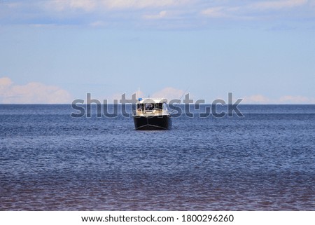 small boat in the distance on the horizon. Big lake