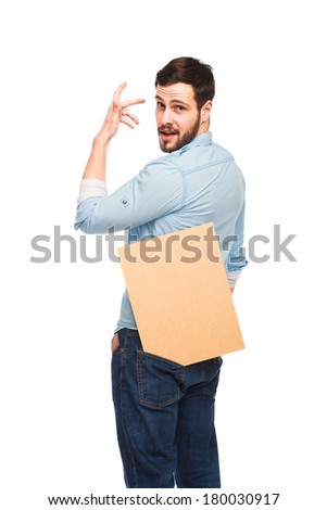 Young expressive handsome man casual dressed smiling and showing a wooden blank panel on white background