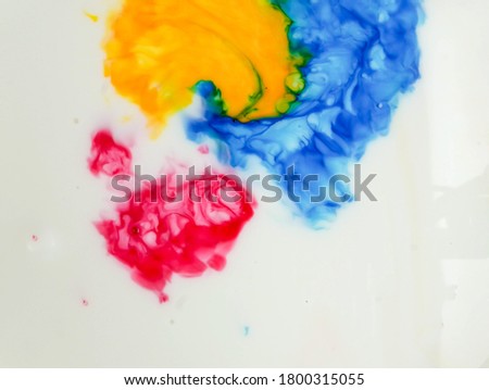 Abstract photo of acrylic colors mix in milk