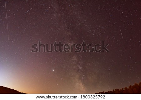 Milky Way and the shooting stars of the Perseid meteor shower in the night.