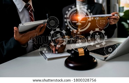 Law and Legal services concept, lawyer meeting and working on table office, law virtual screen interface icons, Background toned image blurred.