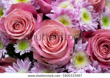 Fresh bouquet of roses and moms  with wood background. Valentines flowers. Romantic card. Bride's bouquet.
