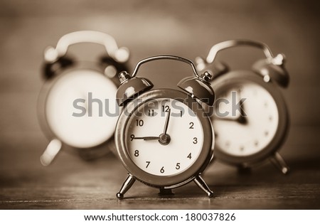 Retro alarm clocks on a table. Photo in retro color image style