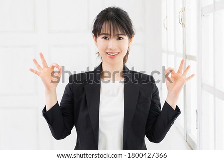 Young woman making an OK gesture shot in the studio
