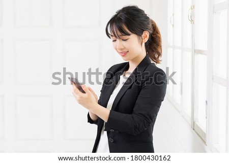 A young woman using a smartphone shot in the studio