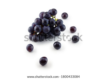 Kyoho grapes (giant mountain grapes) , with some grapes scattered out in front. Isolated on white. 