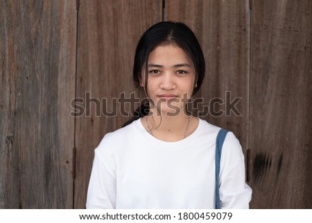 
portrait of an Asian woman smiling on a wooden background