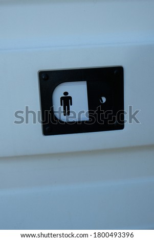 on a white surface there is a toilet sign for men