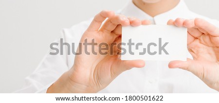  close-up portrait of a young businesswoman with Blank Business Card. High quality photo