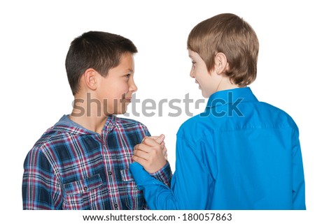 Handshake of two preteen boys on the white background