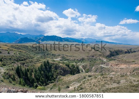The canyon of Charyn river in Almaty area. Panorama of beautiful mountain steppe in the green Tien Shan Mountains in Kegen area in the summer. Rich unique nature of Central Asia.