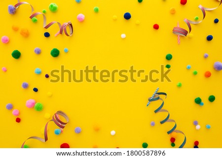 A yellow party background with confetti and a copyspace in the center