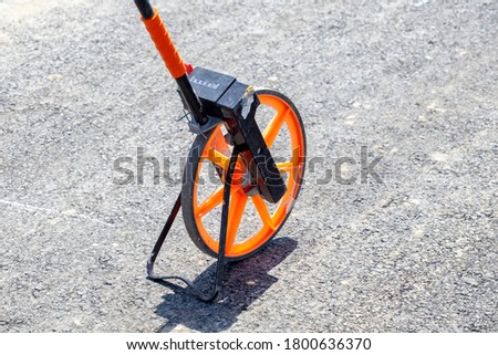 Distance measuring wheel device at the construction site.
 Royalty-Free Stock Photo #1800636370