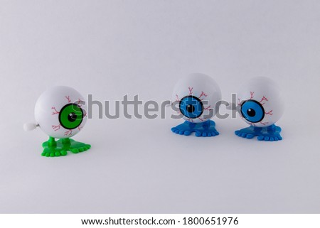 Isolated Mechanical wind up clattering Eye Ball Toys. Concept of being different, the odd one out
