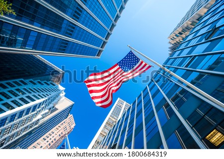 American flag and Modern buildings Royalty-Free Stock Photo #1800684319