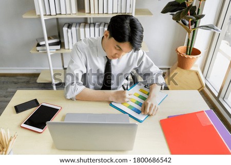 asian businessman sit and work on his desk with laptop computer at office 
