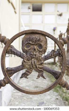 Pirate Skull rusty cemetery gate, symbol