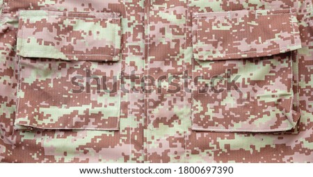 US army acu digital desert uniform shirt background, texture Military camouflage fabric textile closeup view, pocket detail
