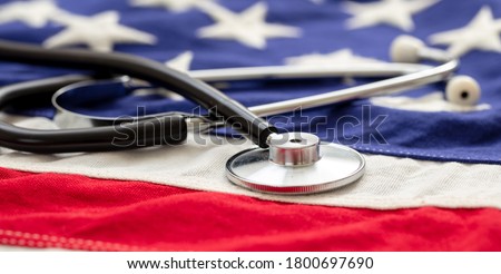 USA health care. Medical stethoscope on a US of America flag, banner. American health insurance concept