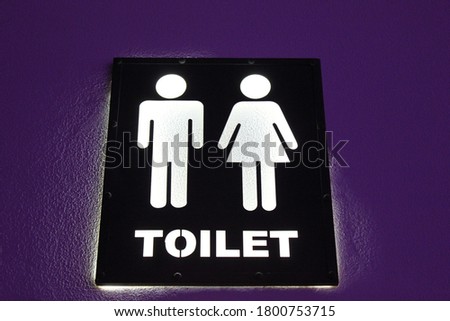 Restroom/toilet sign with icons for men and women.