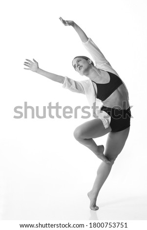 
Young beautiful dancer posing on a studio background. Black and white. Isolated