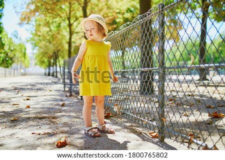 Unhappy and emotional toddler girl in park. Misbehaving child outdoors. Terrible twos and kid tantrums concept