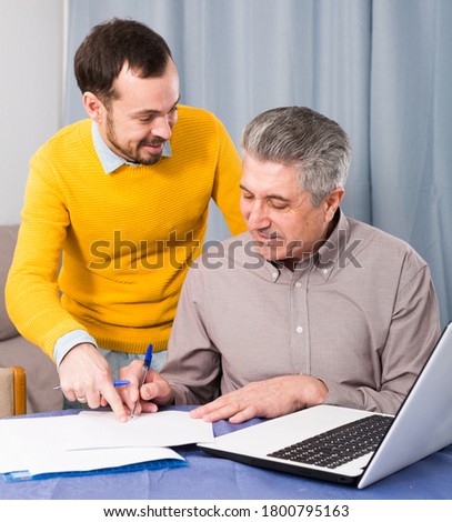 Adult male and sales manager discuss conditions of contract at home