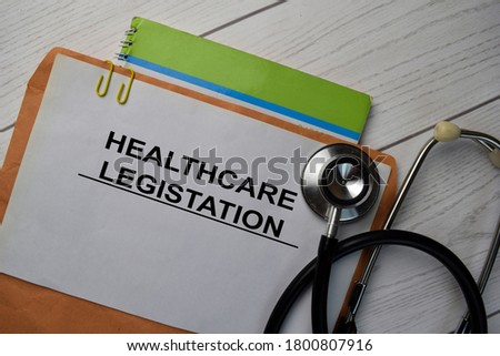 Healthcare Legistation text with document brown envelope and stethoscope isolated on office desk.