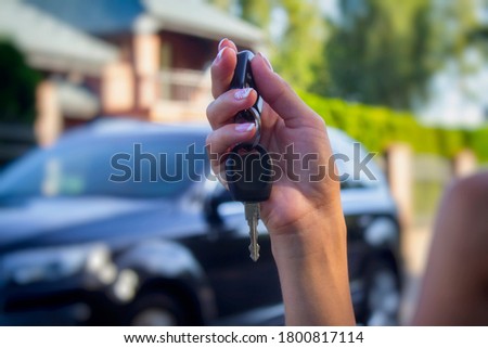 Woman holds the car keys. Concept on the topic of buying and renting a automobile