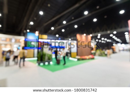 Abstract blur people in exhibition hall background. Exhibition, event, MICE business industry concept.