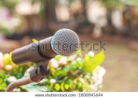 close up microphone over blurred garden background.
