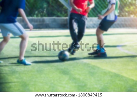 Blurry picture of sport background. Soccer player control and shoot ball to goal with goalkeeper. Soccer players fighting with goalkeeper.