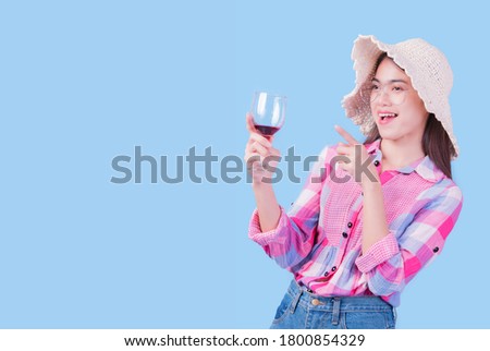 Asian woman having a casual enjoyment at beach party on light blue background with copy space.