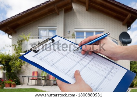 Real Estate Home Property Inspecting And Appraisal By Appraiser Royalty-Free Stock Photo #1800880531