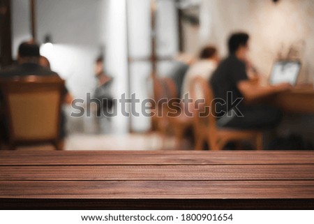 Empty wooden desk space of cafe or office.