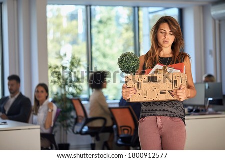 Young woman being sad because she got fired from the office