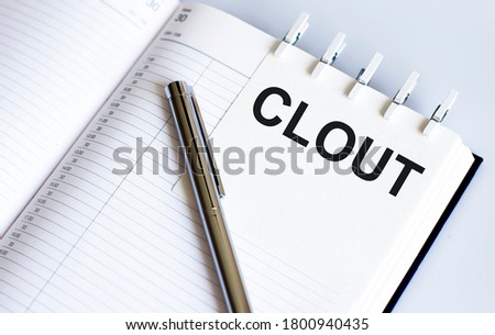text CLOT on short note texture background with pen