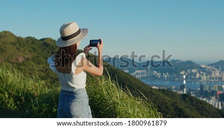 Woman look at the beautiful city view from top