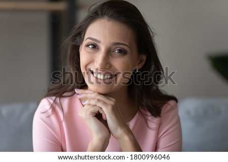 Close up portrait of smiling beautiful indian Arabic woman show white healthy teeth, dental treatment, young mixed race arab brunette female tenant renter pose relax in own new home, tenancy concept