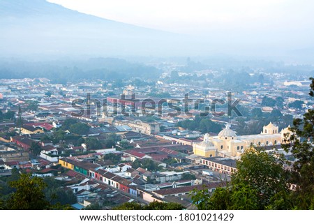 Antigua Guatemala central quarters in the morning mist, main church in the center, downtown