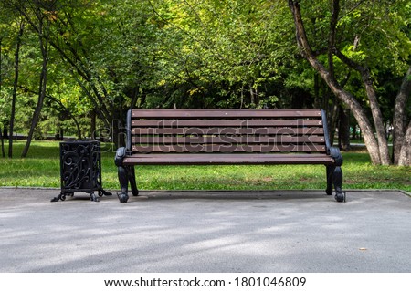 Wooden vintage bench in a public Park. Royalty-Free Stock Photo #1801046809