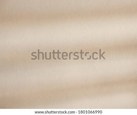 Striped tender beige light shadows on a sand color background. Flat lay with shadow on the wall. Minimal summer concept. Creative copyspace for overlay on product presentation, backdrop and mockup.