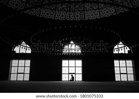 People in silhouette in front of the window in sunlight.
