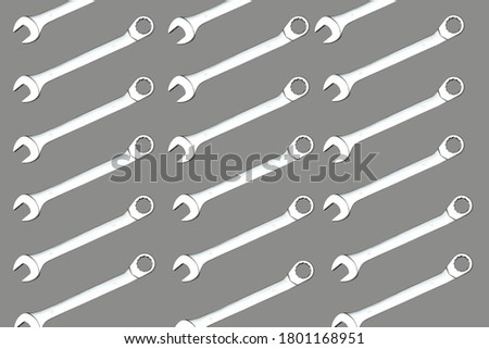 Metal spanner pattern on grey background. horizontal ornament. Template.