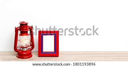 Bookshelf with red frame and red antique lantern on white background