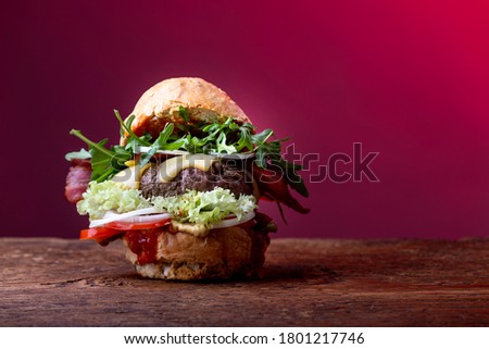 single hamburger on dark wood